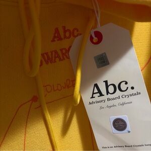 Swarovski Advisory Board Crystals Yellow Hoodie with Red Print